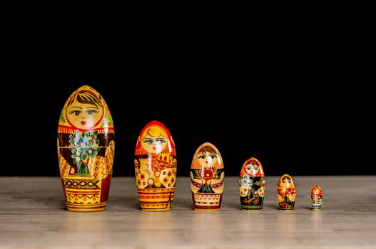 Vintage Russian matryoshka nesting dolls lined on table