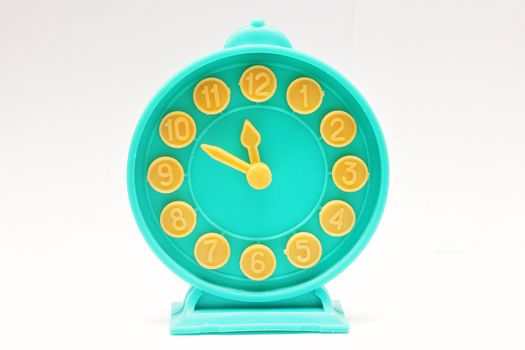 Decorative toy alarm clock on a white background.