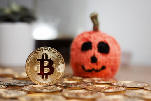 Digital currency physical metal bitcoin coin. Halloween pumpkin concept.