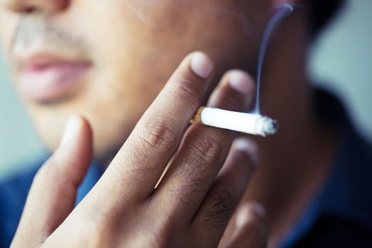 a young man smoking a cigarette