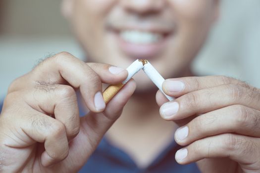 a young man smoking a cigarette