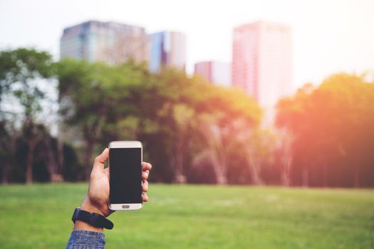 Show phone in hand in the parks.