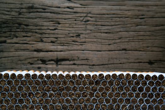 Stack Tobacco Cigarettes with wooden background in vintage retro color.
