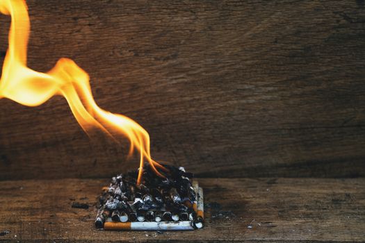 burning cigarette In the wood floor. Campaign no smoking concept.