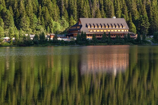 Alpine lake Popradske pleso with touristic shelter - Chata pri popradskom plese, in the morning with a great view on Tatra mountains.