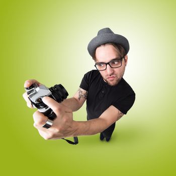 Funny Man with hat and vintage photocamera selfie laugh looks like caricature of himself