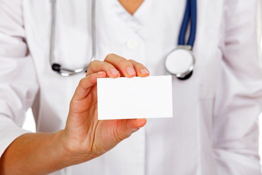 Closeup shot of an empty white card in a hand of doctor or nurse