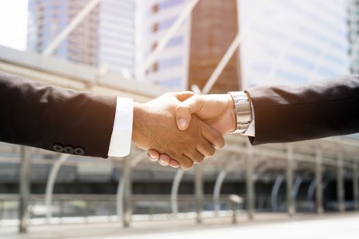 Close Up of a businessman hand shake between two colleagues.or Negotiated agreement successful job