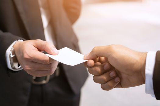 business man in hand hold show business cards blank white card mock up filing give to connect business contacts. Business branding concept.