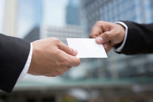 business man in hand hold show business cards blank white card mock up filing give to connect business contacts. Business branding concept.