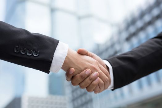 Close Up of a businessman hand shake between two colleagues.or Negotiated agreement successful job.