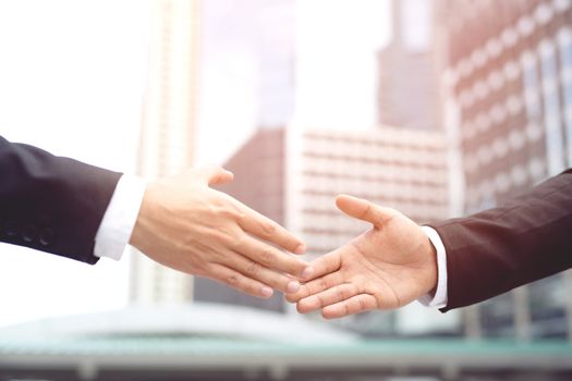 Close Up of a businessman hand shake between two colleagues.or Negotiated agreement successful job.