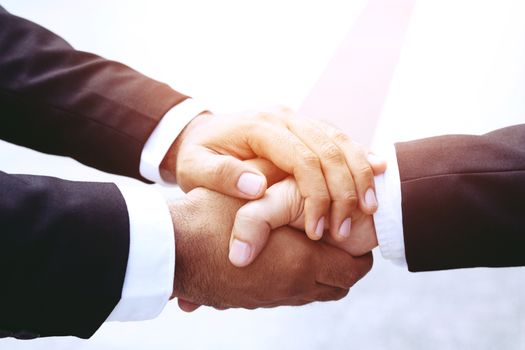 Closeup of a business hand shake between two colleagues OK, succeed in business.
