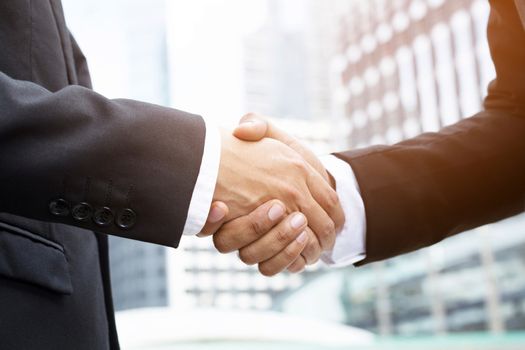 Close Up of a businessman hand shake between two colleagues.or Negotiated agreement successful job