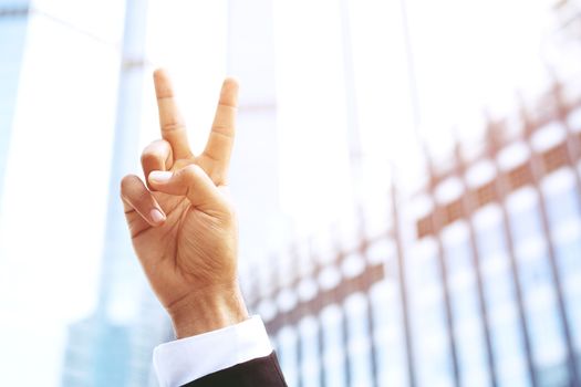 businessman with suit raising showing two fingers up happy cheerful. for good business. concept Success and encouragement to overcome and overcame obstacles.