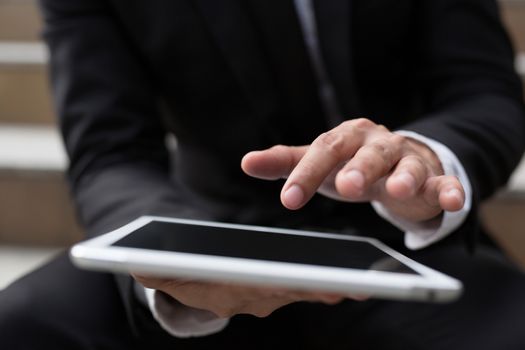 Young businessman using tablet adult working on a digital.