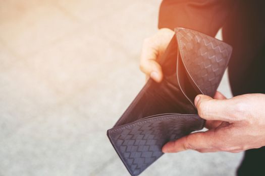 Unhappy bankrupt man with empty wallet . Young man shows her empty wallet. Bankruptcy