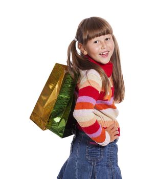 Smiling six years Girl holding presents bags isolated