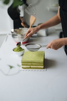 Pour green tea powder over delicious cheesecake