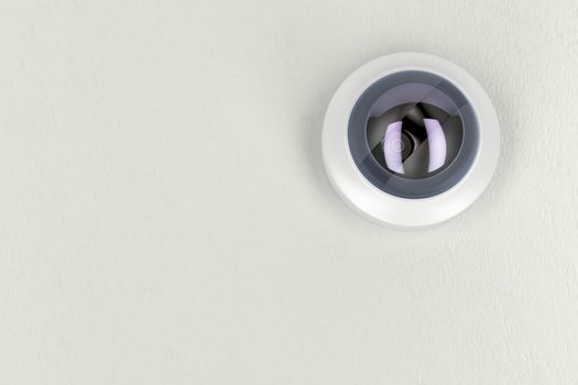 Bottom view of cctv camera on white ceiling