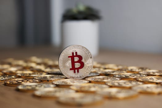 Digital currency physical metal bitcoin coin on the gold money background. Money concept.