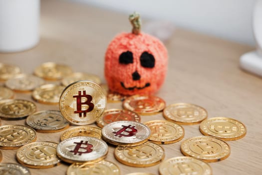 Digital currency physical metal bitcoin coin. Halloween pumpkin concept.