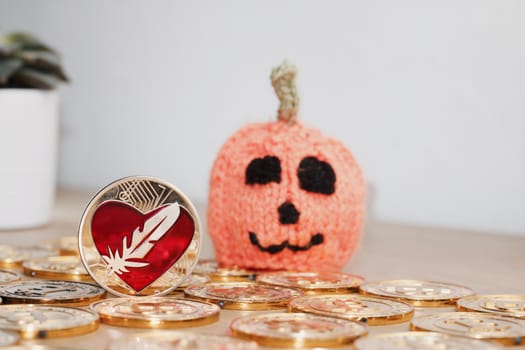 Digital currency physical metal bitcoin coin. Halloween pumpkin concept.