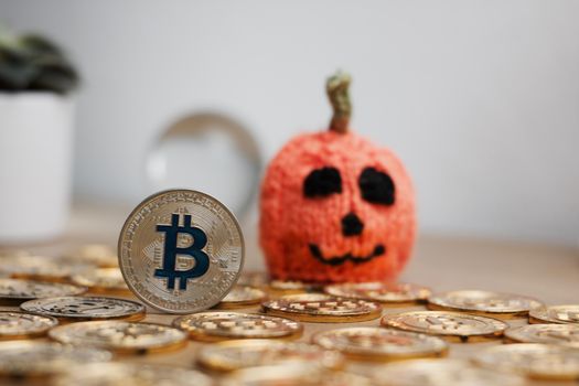 Digital currency physical metal bitcoin coin. Halloween pumpkin concept.