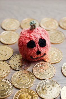 Digital currency physical metal bitcoin coin. Halloween pumpkin concept.