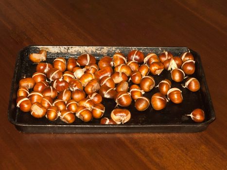 tray of freshly cooked roasted chestnuts autumn forage food kitchen home; essex; england; uk