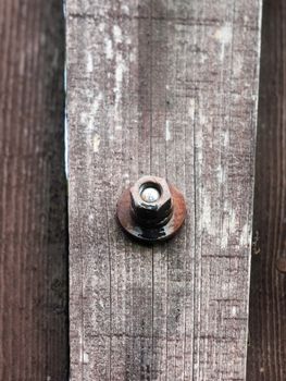 close up of old rusty screw head on rustic wooden fence; essex; england; uk