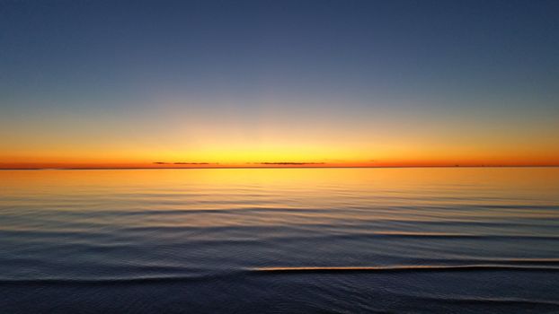beautiful orange sunset on silent sea water