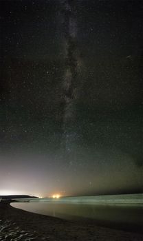 night sky with stars and milky way over beach