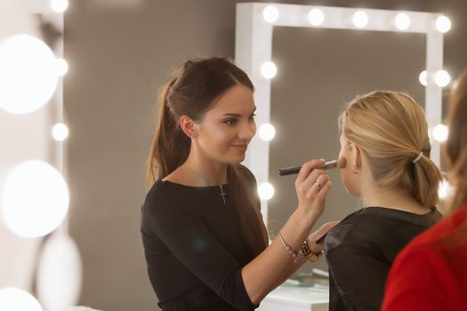 Make-up artist work in her studio. fashion