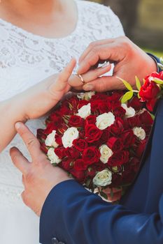 wedding rings and hands of bride and groom. young wedding couple at ceremony. matrimony. man and woman in love. two happy people celebrating becoming family.