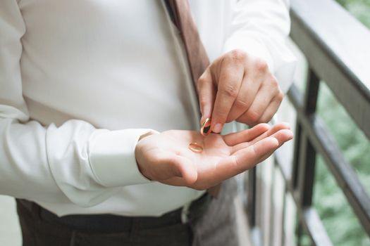 Man is taking off the wedding ring.