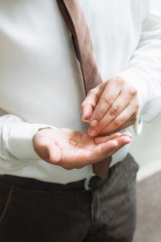 Man is taking off the wedding ring.