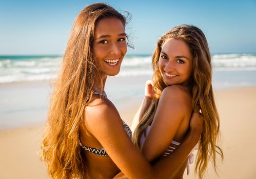 Best friends having fun on the beach 