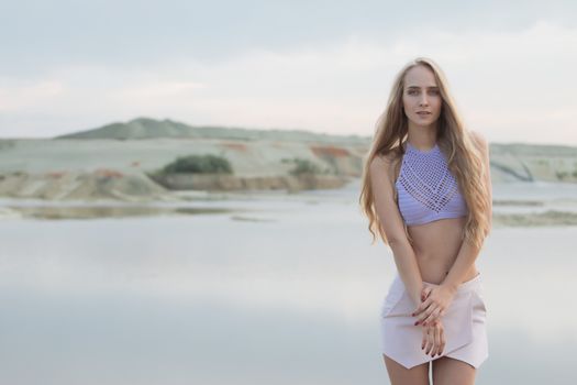 Girl in swimsuit at the sea. High fashion look.glamor beautiful sexy stylish blond. Caucasian young woman model.