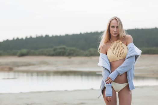 Girl on the sandy beach in a bathing suit.