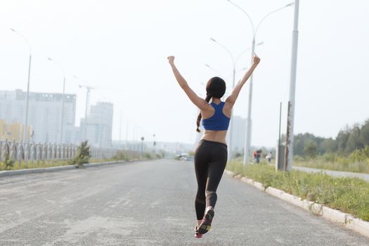 Young adult woman performs breathing exercise. Girl goes in for sports. Close up.