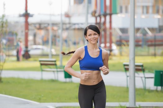 Young fitness woman running at seaside.Girl on the run