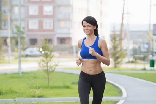 Young fitness woman running at seaside.Girl on the run