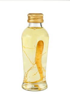 Close up of one glass jar bottle of ginseng root essence extraction liquor with golden cap, isolated on white background, low angle side view