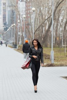 Portrait of happy woman after shopping in the city.