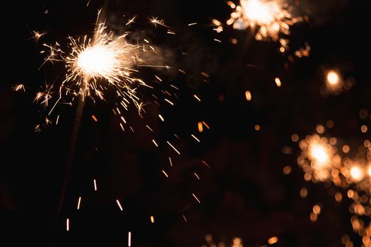 Picture showing group of friends having fun with sparklers.