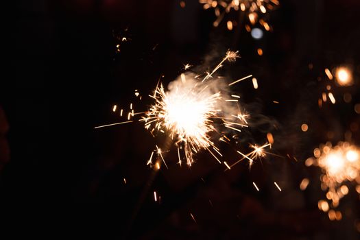 Picture showing group of friends having fun with sparklers.