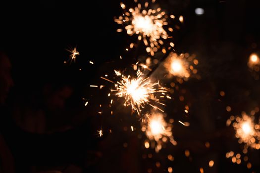 Picture showing group of friends having fun with sparklers.