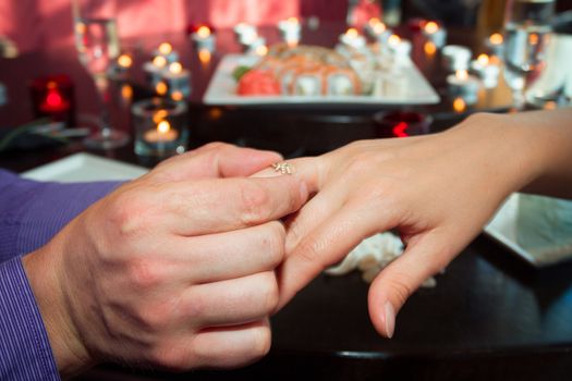 Joyful man making proposal to his future wife.