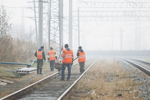 Railroad workers maintaing railways. checking construction